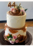 Western tiered cake with 3D printed cowboy themed decorations